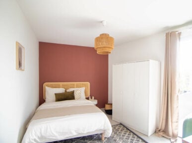 chambre à louer à Lyon (69) par Colivys, mur rouge, placard blanc, lit chaleureux